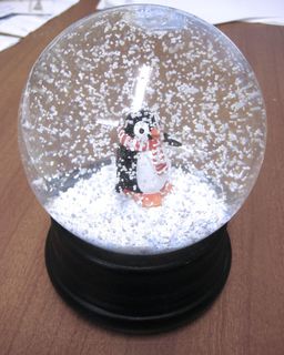 A penguin in a snowglobe